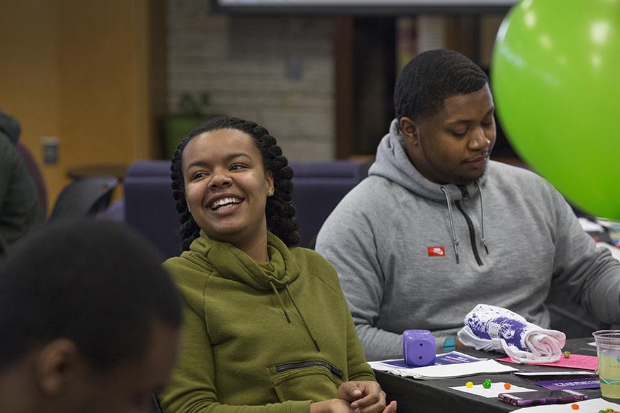 Two student sit and laugh together.