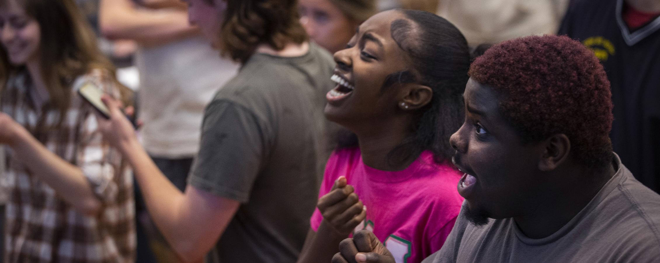 Two students laugh together at a campus event.